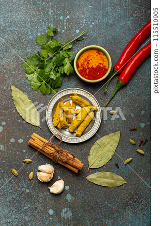 Various Indian spices and herbs arranged on a rustic background . Various Indian spices and herbs arranged on a rustic background . 115510905