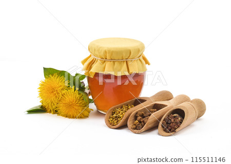 A jar of honey with fabric lid, pollen granules, beebread, and dandelion flowers A jar of honey with fabric lid, pollen granules, beebread, and dandelion flowers 115511146