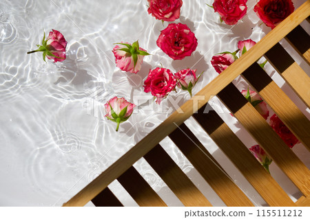Roses Floating in Sunlit Water with Wooden Ladder 115511212