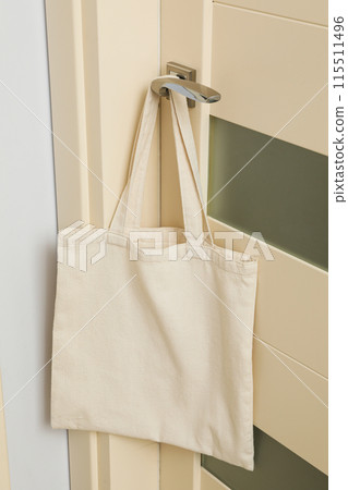 The bag hangs on the doorknob in the room The bag hangs on the doorknob in the room 115511496