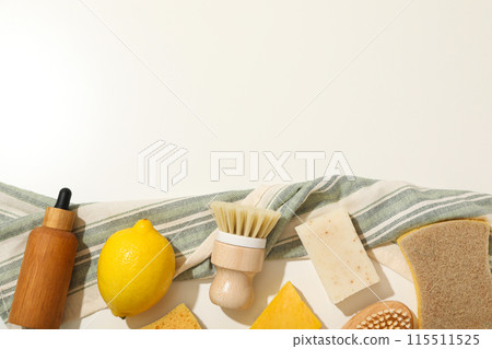Natural cleaning products, bottle and towel on light background, space for text 115511525
