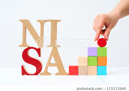 Wooden alphabet blocks arranged with "NISA" 115511640