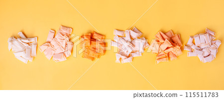 Bunches of snus bags with different flavors and different colors on a yellow background 115511783