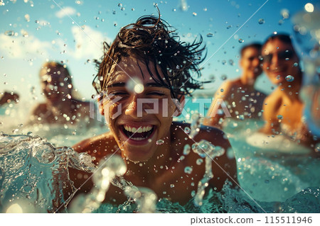 Joyful Group of Friends Splashing in Sea at Sunset 115511946