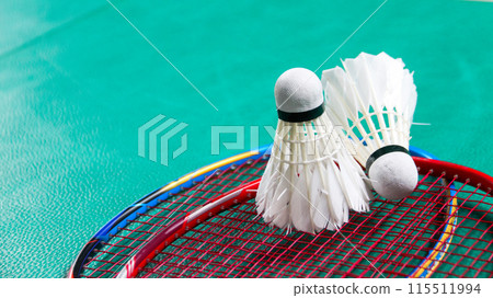 Badminton shuttlecocks on badminton rackets in badminton court soft and selective focus Badminton shuttlecocks on badminton rackets in badminton court soft and selective focus 115511994