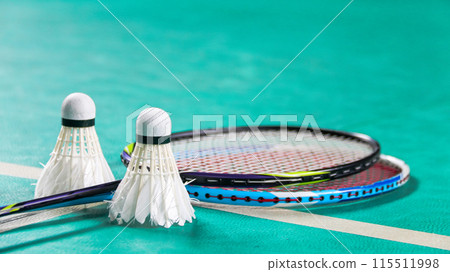 Badminton shuttlecocks on badminton rackets in badminton court soft and selective focus Badminton shuttlecocks on badminton rackets in badminton court soft and selective focus 115511998