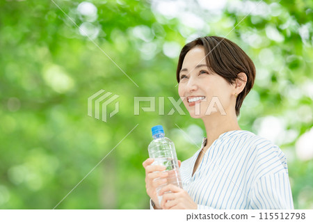 Woman drinking water, fresh greenery Woman drinking water, fresh greenery 115512798