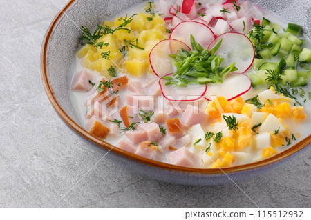 Traditional Russian summer cold soup okroshka with kefir in ceramic bowl on rustic wooden table Traditional Russian summer cold soup okroshka with kefir in ceramic bowl on rustic wooden table 115512932