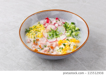 Traditional Russian summer cold soup okroshka with kefir in ceramic bowl on rustic wooden table Traditional Russian summer cold soup okroshka with kefir in ceramic bowl on rustic wooden table 115512938