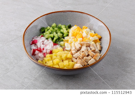 Okroshka smoked chicken breast - Russian cold soup with vegetables on white wooden background. Selective focus Okroshka smoked chicken breast - Russian cold soup with vegetables on white wooden background. Selective focus 115512943