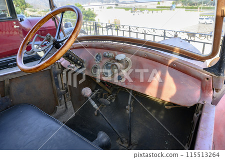 Interior of an old convertible retro car from the beginning of the 20th century 115513264