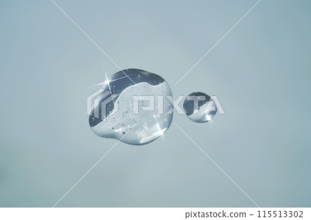 Drop of serum shimmering in the sun on a blue background. 115513302