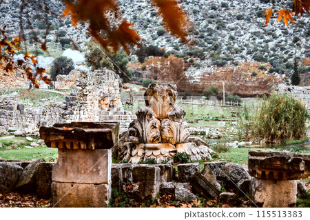 Decorated stone ruins with autumn leaves 115513383