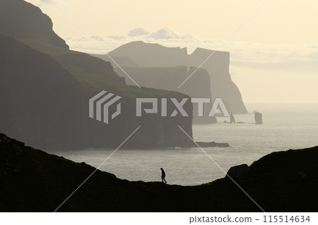 Traveler silhouette on background of famous Risin og Kellingin cliffs 115514634