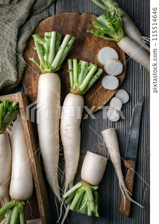 Whole and sliced white daikon radish roots 115514646