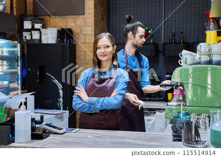 Colleagues partners young man and woman in aprons working together in coffee shop 115514914