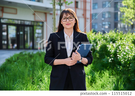 Portrait of business mature woman with digital tablet, outdoor Portrait of business mature woman with digital tablet, outdoor 115515012