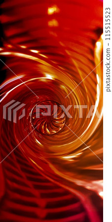 Curved red glass. Multi-colored glass. Creative background image. Spiral funnel with an ornament in the center. 115515523