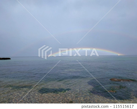 In the sea, a rainbow connects the ships. 	In spring, the water in the Black Sea is clear. A rainbow is visible on the horizon. 115515617