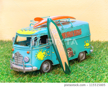 [Material] A replica of a typical Combi Camper with a surfboard attached to the roof. 115515805