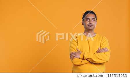 Portrait of cheerful friendly indian man smiling, looking pleased, isolated over yellow studio background. Happy expressive asian person grinning, feeling satisfied, camera B Portrait of cheerful friendly indian man smiling, looking pleased, isolated over yellow studio background. Happy expressive asian person grinning, feeling satisfied, camera B 115515983