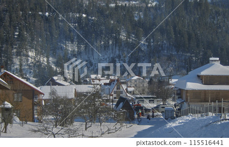 Winter holidays in the Carpathian mountains.Mountain slopes covered in snow, lots of tourists, tourist lodges, holiday homes and of course ski slopes. Winter holidays in the Carpathian mountains.Mountain slopes covered in snow, lots of tourists, tourist lodges, holiday homes and of course ski slopes. 115516441