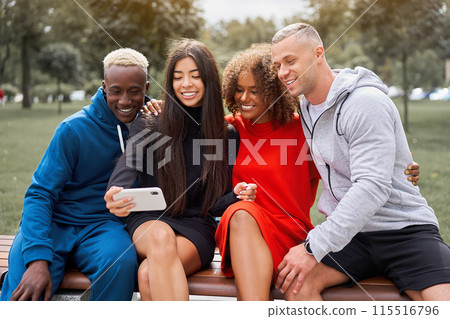 Smiling young diverse friends taking selfie on 115516796