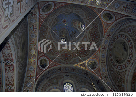 The dome of the Church of the Resurrection of Christ in Crimea.View of the dome from the inside. Multi-colored marble cladding with mosaic. A ray of sunlight enters the temple through a stained glass The dome of the Church of the Resurrection of Christ in Crimea.View of the dome from the inside. Multi-colored marble cladding with mosaic. A ray of sunlight enters the temple through a stained glass 115516820