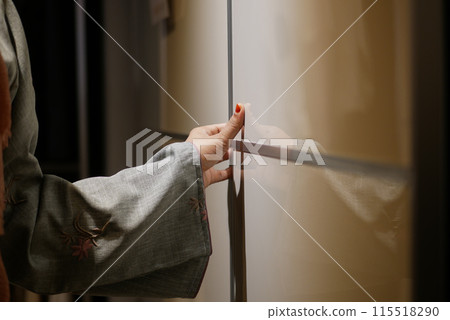 women hand open a kitchen cabinet drawer women hand open a kitchen cabinet drawer 115518290