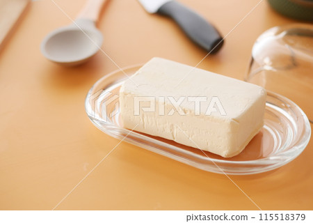 fresh butter in a glass jar on table  115518379