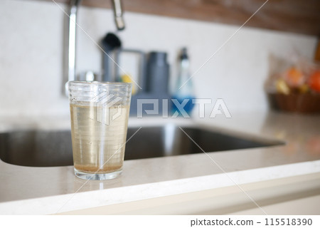 dirty glass of water in a kitchen environment dirty glass of water in a kitchen environment 115518390