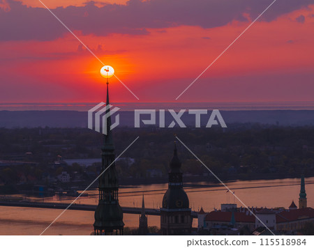 Magical aerial sunset over Riga old town, the capital of Latvia. Riga rooftop view panorama at sunset with urban architectures and Daugava River. 115518984