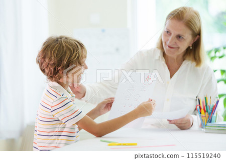 Child holding school test with excellent A grade. 115519240
