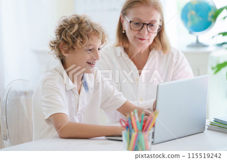 Child in school. Student in class. Boy at homework 115519242