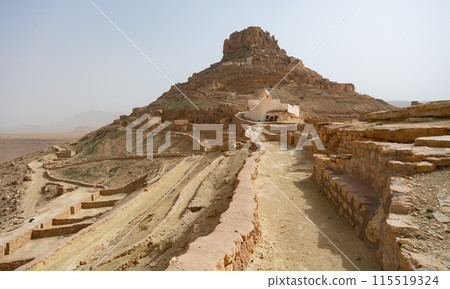 Deserted village of Ksar Guermessa with white mosque in Tunisia Deserted village of Ksar Guermessa with white mosque in Tunisia 115519324