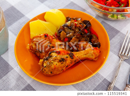 Baked chicken legs with stewed vegetables and boiled potatoes closeup 115519341