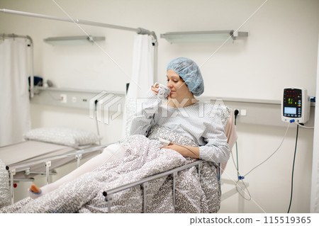 Young woman in hospital recovery room after surgery Young woman in hospital recovery room after surgery 115519365