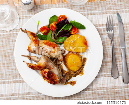 Fried quail served with potatoes and salad Fried quail served with potatoes and salad 115519373