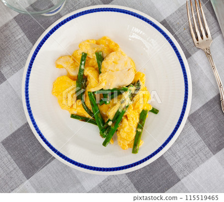 Hearty breakfast is served on plate - omelette and chicken breast, complemented by asparagus. Hearty breakfast is served on plate - omelette and chicken breast, complemented by asparagus. 115519465