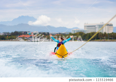 Banana boat ride. Kids on the beach. Banana boat ride. Kids on the beach. 115519466