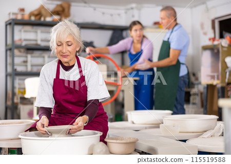 lady works on potter's wheel lady works on potter's wheel 115519588