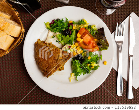 Artichoke omelette served with vegetable salad Artichoke omelette served with vegetable salad 115519658