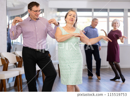 Middle-aged man and elderly woman are dancing contemporary twist in couple Middle-aged man and elderly woman are dancing contemporary twist in couple 115519753