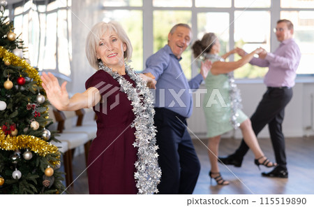 In studio decorated for New Year, elderly man and woman perky dance pair discofox. In studio decorated for New Year, elderly man and woman perky dance pair discofox. 115519890