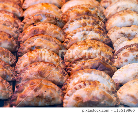 Appetizing savory empanadas showcased on countertop display 115519960