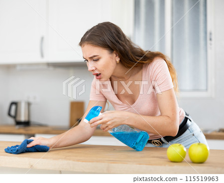 Young woman doing wet cleaning of the kitchen 115519963