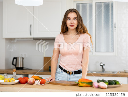 Portrait of a young confident woman in the kitchen Portrait of a young confident woman in the kitchen 115520459
