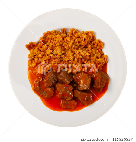 There is portion of hearty food on plate - pearl barley with beef stew in tomato sauce 115520537