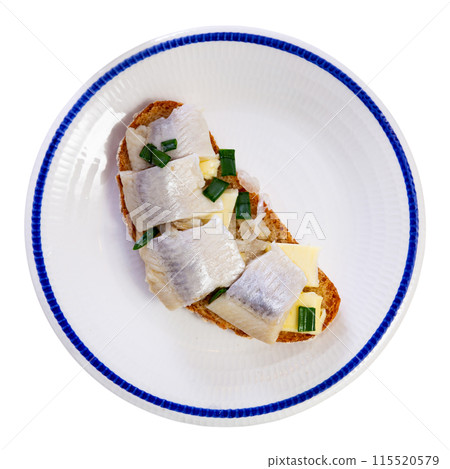 On plate - homemade light snack toast, sandwiches with herring, butter, decorated with green onion 115520579