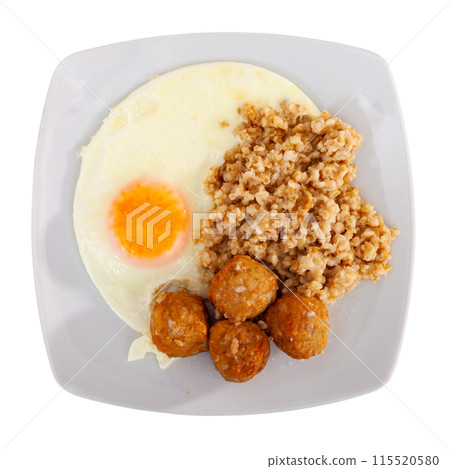 Small portion of oatmeal, stewed meatballs and fried egg 115520580
